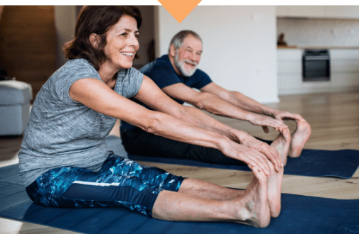 Older couple doing stretches on yoga mat